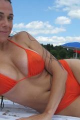 Laying out in a tight orange bikini