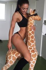 Stephanie Davis riding a giraffe.
