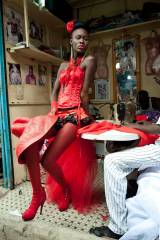 A model poses in front of tailor stalls in the cen...
