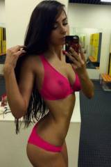 Sexy brunette selfie in the mirror of the gym