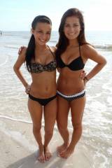 Two dark haired vixens on the beach