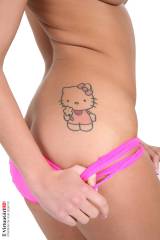 Angelica Black showing her Hello Kitty tattoo.