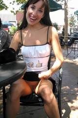 Subtly flashing her pussy in an outdoor cafÃ©