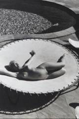 Marilyn Monroe lying naked on a trampoline, 1953.