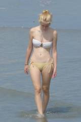Young blond girl walking on the beach