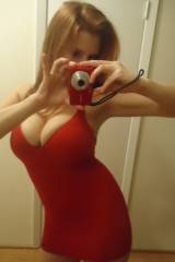 selfie of a redhead in a red dress