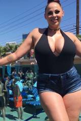 Gianna Michaels in denim shorts and a tight top