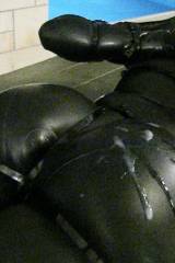 Latex Lucy encased in tight black rubber, bound wi...