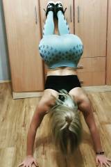 Blonde with a heart shaped ass doing a handstand against the wall.