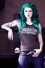 Chick with neon green/turquois hair and ink. Her b...