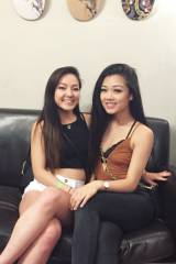 Asian babes on a black leather couch