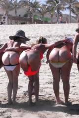 Girls mooning on the beach
