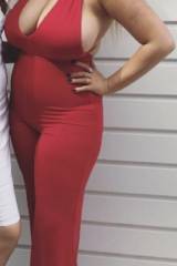 Giant tits barely contained by a red jumpsuit